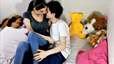 Stepsister passionately kissing stepbrother on bed surrounded by teddy bears