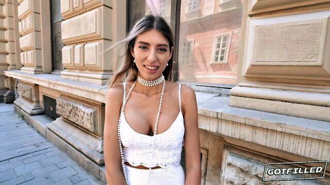 Busty curvy blonde in tight white lace top flashing huge tits and deep cleavage outdoors