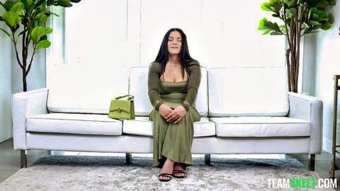 Jay Killa in sexy green dress sitting elegantly