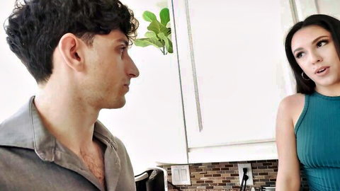 Selena Ivy in teal dress facing her boss in intimate kitchen scene