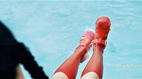 Toned babe's sexy long legs in red strappy high heel sandals splashing in pool