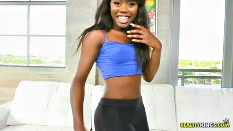Amanda Pink smiling in blue crop top and black leggings, fit ebony body
