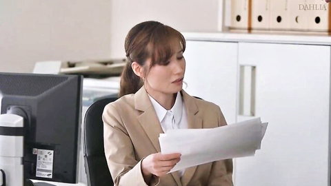 Sexy Asian office boss babe in tight suit blouse holds papers at desk teasing employee surprise