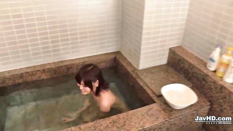 Yua Ariga nude in steamy bathtub smiling in JAV handjob video