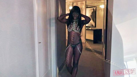 Ana Foxxx in revealing chain lingerie posing seductively, exposing ebony curves