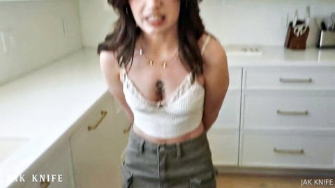 Chanel Camryn teasing in cropped top and jeans, intense expression