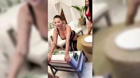 Smiling brunette MILF in red lingerie and stockings bending over teasing ass