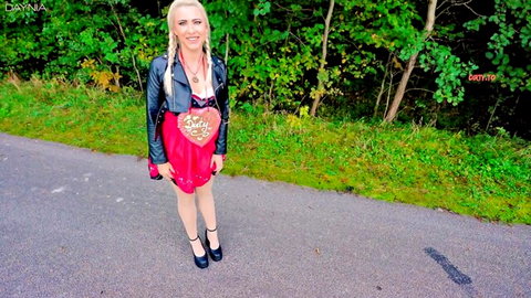 Blonde MILF Daynia in red heart dress, leather jacket, outdoor POV fetish