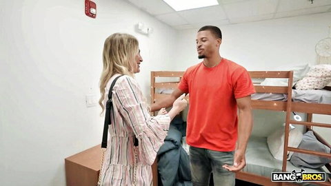 Blonde MILF in striped dress flirts with muscular black inmate in red shirt in bunk room