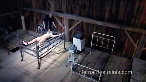 Brunette slave girl naked and restrained, throat stretched by plastic sack in BDSM