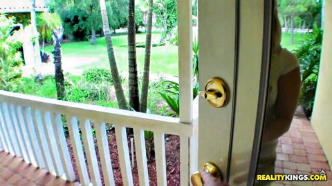 Curvy white woman in tight shorts bends over at outdoor door teasing her big ass