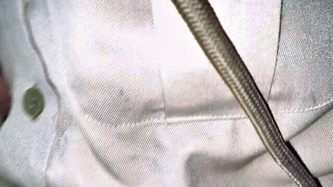 Blurry closeup of white police uniform shirt with thick veiny cock pressed against fabric