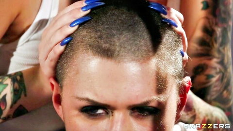 Tattooed bald man gripped hard by woman's long blue nails on head in intense rough scene
