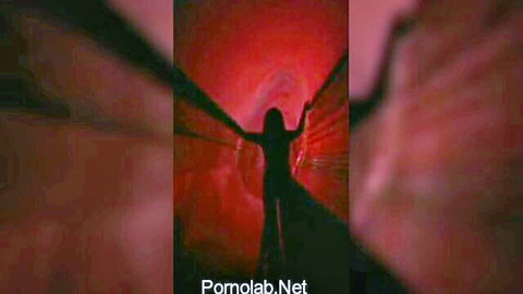 Silhouette of woman arms outstretched in glowing red tunnel vintage retro porn