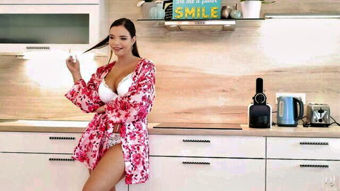 Curvy brunette in open floral robe exposing huge tits in white bra smiles seductively holding mug in kitchen