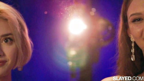 Lena and Olivia smiling seductively in close-up lesbian tease