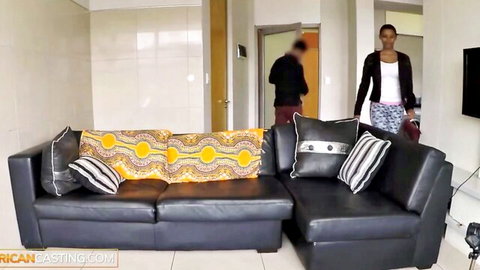 Short-haired African babe in casual top and pants during steamy interview