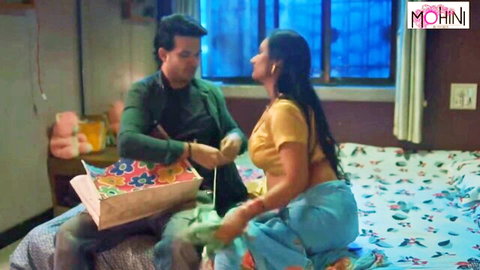 Curvy Indian MILF with big tits in yellow top receives gift from man on bed