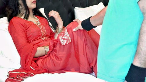 Curvy Indian brunette in red embroidered dress spreads legs for man's rough hand groping her crotch on bed