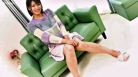 Smiling Asian mature woman in sweater and skirt spreads legs teasingly