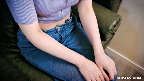 Asian woman in cropped purple top and jeans, showing midriff, sitting solo