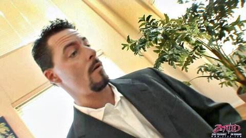 Shocked suited man with goatee and surprised expression in office setting