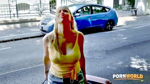 Blonde with big tits in tight yellow tank top moaning ecstatically outdoors by blue car
