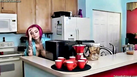 Submissive pink-haired skinny MILF with huge fake tits exposed in open robe sits distressed in kitchen