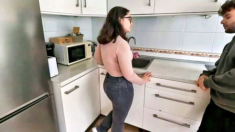 Curvy brunette teen in backless top and tight jeans with roommate in kitchen