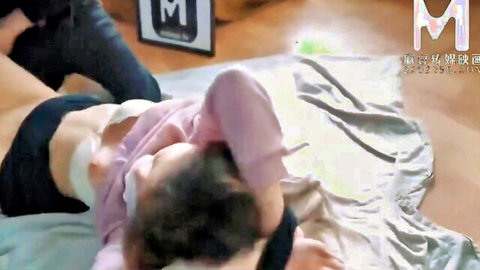 East Asian woman in pink top exposing underboob grabbed roughly by man on bed