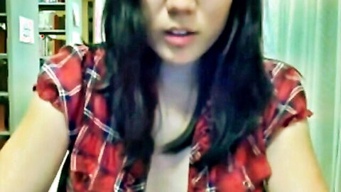 Naughty Asian teen in red plaid blouse teases with cleavage in library