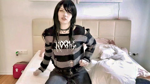 Emo teen girl in ripped NOFX striped sweater sitting on bed teasing with choker