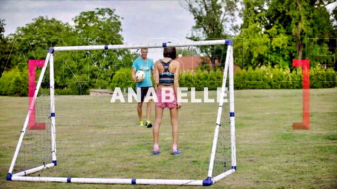 Brunette with big ass in tight pink shorts poses at outdoor soccer goal with boyfriend