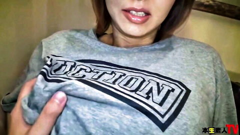 Seductive Asian JAV star lifts gray hoodie to flash perky bare tits