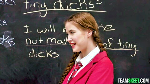 Gracie Gates in pink school uniform writing punishment on blackboard in detention