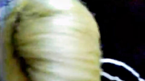 Closeup of sexy blonde woman's thick wavy hair from side view