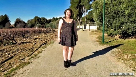 French BBW in floral dress smiling outdoors, ready for threesome fun