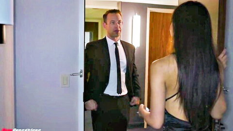 Asian MILF Alexis in backless black dress with Brad Newman at hotel door