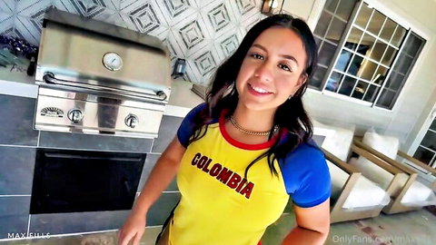 Sexy smiling Colombian Latina in tight yellow Colombia soccer jersey posing by outdoor grill