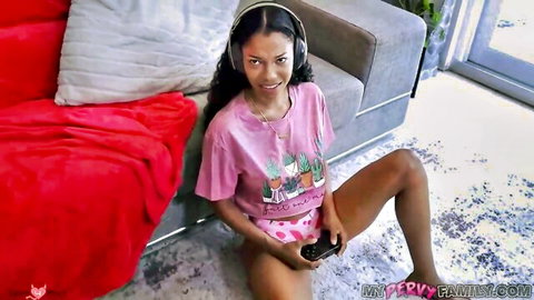 Ebony babe in pink panties spreads legs wide gaming with headset on couch