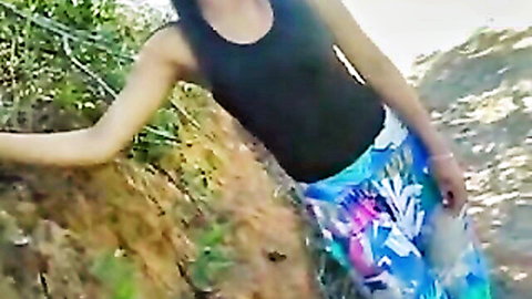 Sexy Brazilian teen bending over outdoors in tight colorful shorts teasing her round ass