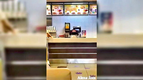 Empty McDonald's counter with menu boards, registers and no people visible