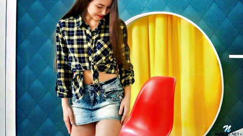 Sexy brunette babe in tied yellow plaid shirt and tiny denim miniskirt posing seductively