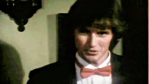 Vintage suited man in classic porn scene with bowtie expression
