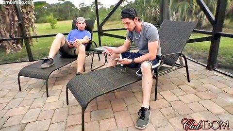 Clubdom's Mena Li and Mistress Rachael with submissive cuckold men lounging outdoors