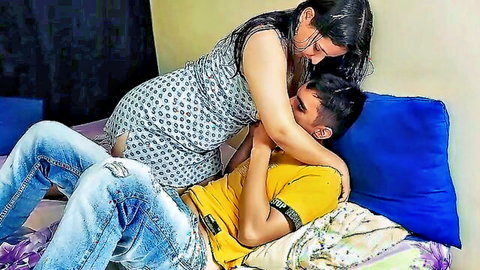 Latina woman straddling boyfriend in passionate embrace on bed