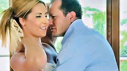 Blonde big-titted MILF in dress passionately kissing suited man