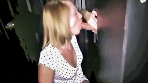 Blonde babe in polka dot dress sucks thick cock through glory hole