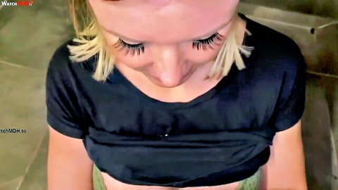 Blonde babe with huge tits and fake lashes teasing deep cleavage in tight black top