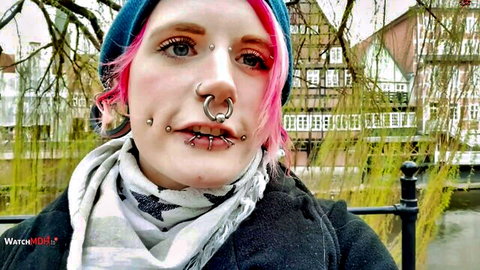 Laura Linde with pink hair, piercings, and tattoos in outdoor teaser for her big tits POV debut